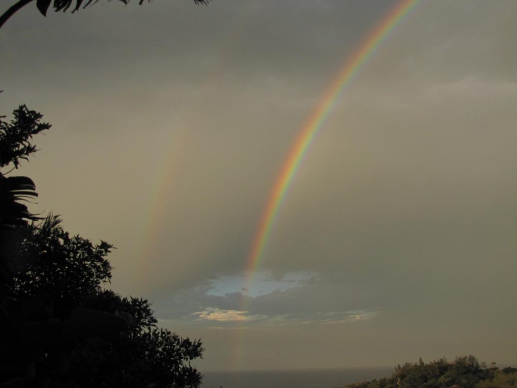 Two rainbows in a cloudy sky