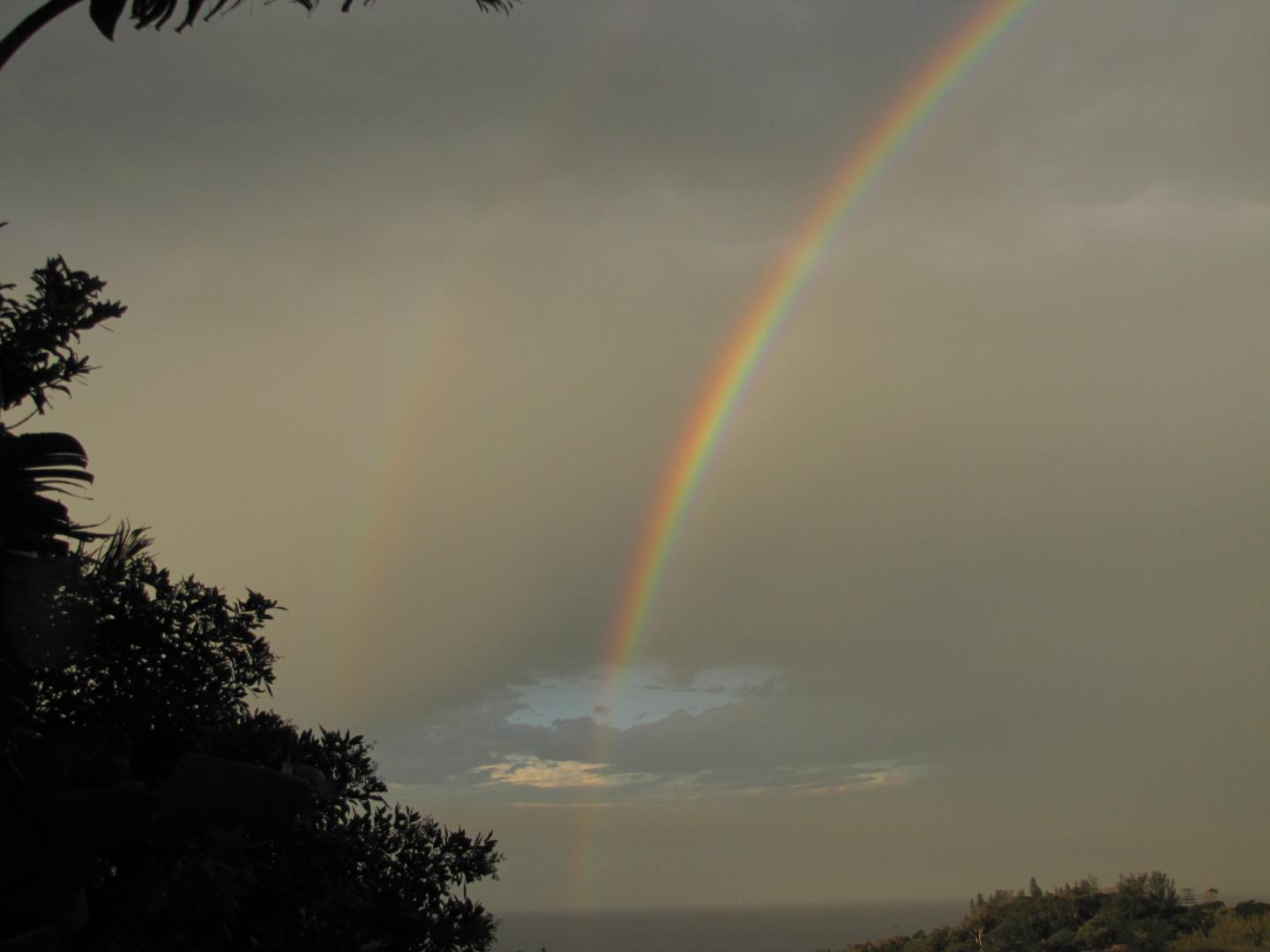 Two rainbows in a cloudy sky